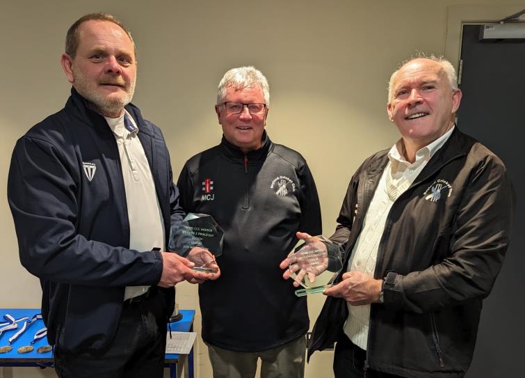 Umpires Jon Willington and Rob Bellerby receive their trophies from Martin Jones
