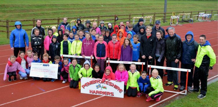 Members of Pembrokeshire Harriers with their cheque for £1,500 from Community Chest funding