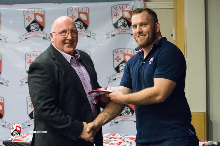 Phil receives his cap from a current Maltese international