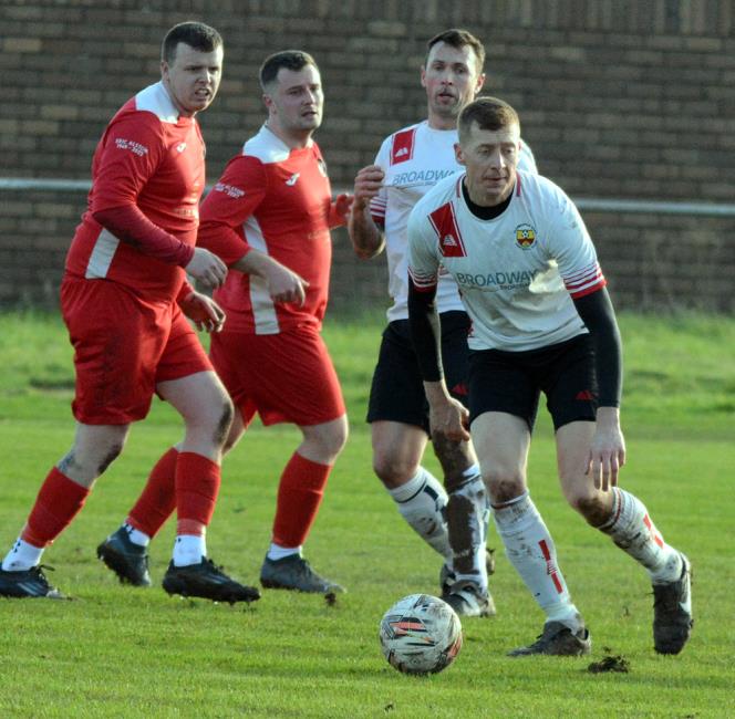 Defender Matthew Davies clears the danger for Clarbeston Road against Milford United