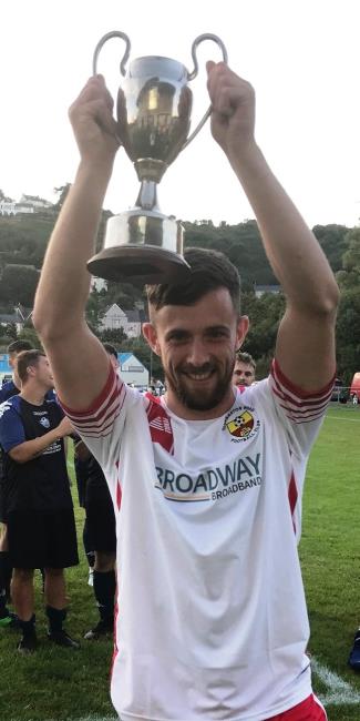 Reinallt George raises the trophy aloft