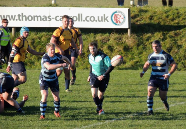 Rhys Lane gets the ball away.