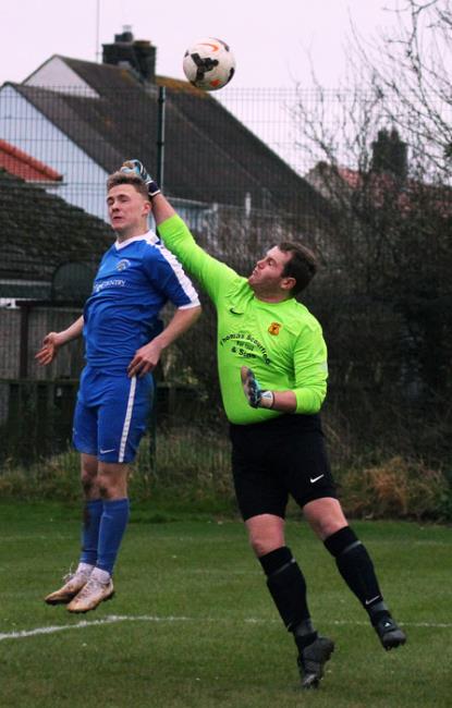 Will Haworth who opened the scoring for Merlins Bridge is beaten to the ball by Tom Davies