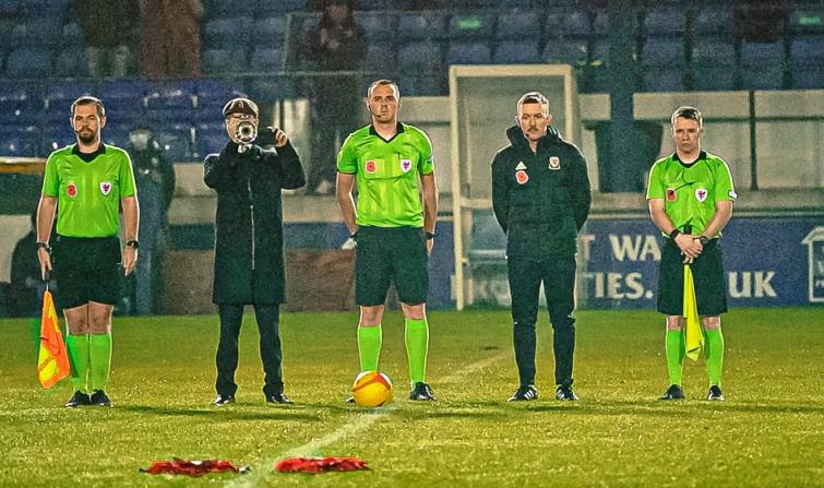 Match officials observe the last post played by Tom Jordan