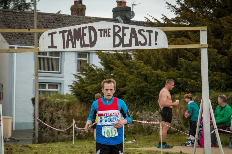 Tim Mills crosses the finishing line