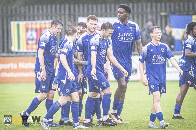 Haverfordwest County celebrate scoring on the Ogi Bridge Meadow Stadium