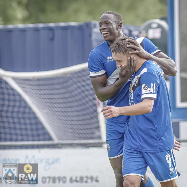 Ben Fawcett celebrates with Alhagi Touray Sisay