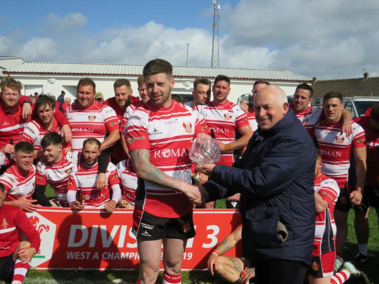 Mariners skipper Jamie Lewis recieves glassware from WRU representative Gordon Eynon