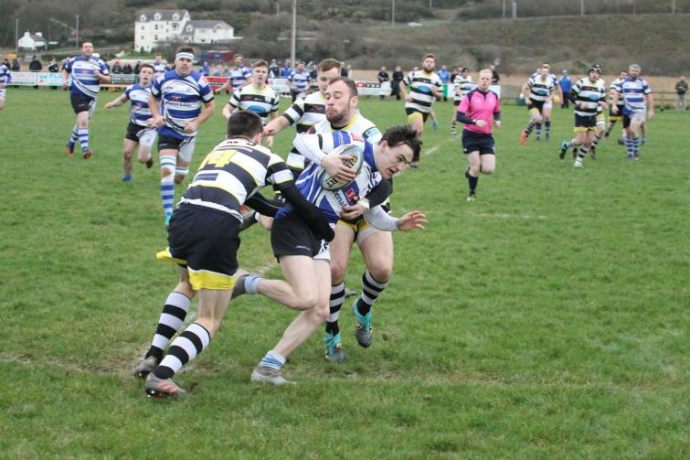 Fishguards Robbie Jones is caught bt Tumbles cover defence.